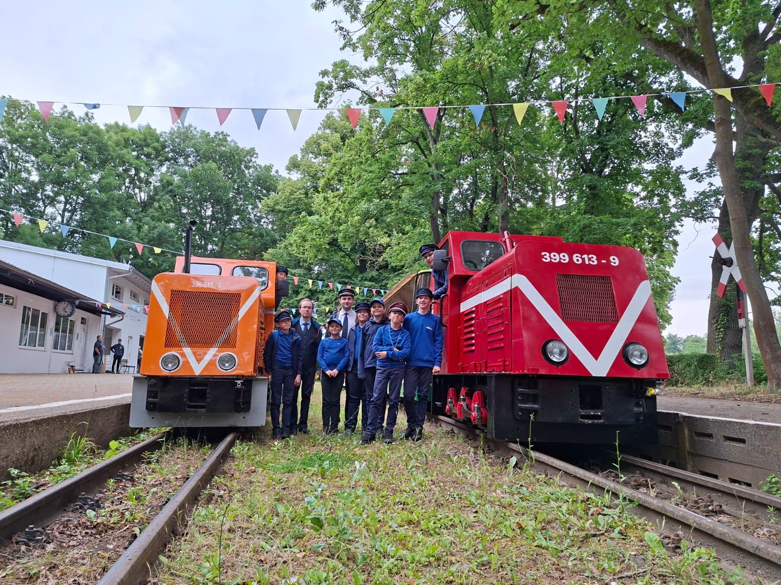 Dresdner Kinder in Uniform vor zwei Zügen der Parkeisenbahn Halle